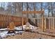 Wooden pergola with two chairs in a backyard setting at 527 Mossycup Dr, Fairburn, GA 30213