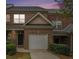 Brick townhouse exterior with a white garage door and landscaping at 141 Mill Pond Xing # C2, Carrollton, GA 30116