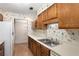 Galley kitchen with wood cabinets and double sink at 109 Ridley Howard Ct, Decatur, GA 30030