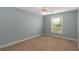 Light blue walls and carpet flooring in this spacious bedroom at 170 Amicalola Way, Jonesboro, GA 30236