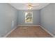 Light blue walls and carpet flooring in this spacious bedroom at 170 Amicalola Way, Jonesboro, GA 30236