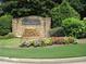 Stone entrance sign to the Falling Waters community with landscaping at 170 Amicalola Way, Jonesboro, GA 30236