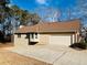 Tan siding house with a two car garage and driveway at 170 Amicalola Way, Jonesboro, GA 30236