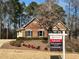 Brick house for sale with a well-maintained lawn and landscaping at 170 Amicalola Way, Jonesboro, GA 30236