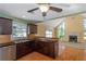 Kitchen features dark wood cabinets, granite countertops, and stainless steel appliances at 170 Amicalola Way, Jonesboro, GA 30236