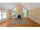 Spacious living room with hardwood floors, a fireplace, and large windows at 170 Amicalola Way, Jonesboro, GA 30236