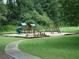 Community playground with playset, swings, picnic tables, and walking path at 170 Amicalola Way, Jonesboro, GA 30236