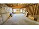 Unfinished basement area with exposed beams and brick at 170 Amicalola Way, Jonesboro, GA 30236