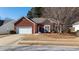 Brick ranch home with attached garage and landscaped yard at 175 Robin Ct, Fayetteville, GA 30215