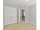 Spacious bedroom with double doors and carpet at 2297 Elmbridge Rd, Buford, GA 30519