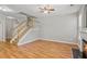 Living room with hardwood floors, fireplace and stairs to upper level at 2297 Elmbridge Rd, Buford, GA 30519