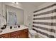 Bathroom with single vanity, striped shower curtain, and neutral decor at 4334 Austin Farm Trl, Acworth, GA 30101