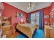 Cozy bedroom with red walls, full-size bed, and built in shelving at 4334 Austin Farm Trl, Acworth, GA 30101