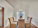 Formal dining room with glass table, chandelier, and hardwood floors at 4334 Austin Farm Trl, Acworth, GA 30101