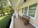 Covered porch with wooden bench, overlooking landscaped yard at 5791 Warren Farm Sw Rd, Powder Springs, GA 30127