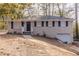 Ranch style home with gray brick exterior, black shutters, and attached garage at 4083 Thetford Ct, Decatur, GA 30035