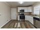 Kitchen with white cabinets, stainless steel appliances, and granite countertops at 4083 Thetford Ct, Decatur, GA 30035