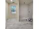 Modern bathroom with subway tile shower and gray vinyl flooring at 188 Oak Dr, Atlanta, GA 30354