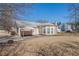 Back exterior of a home with a round sunroom, patio, and large yard at 2210 Burdett Ridge, Atlanta, GA 30349