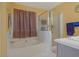 Bright bathroom featuring a soaking tub, glass door shower, and a single sink vanity at 2210 Burdett Ridge, Atlanta, GA 30349