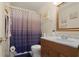 Cozy bathroom featuring a modern vanity with brown cabinets and a blue patterned shower curtain at 2210 Burdett Ridge, Atlanta, GA 30349