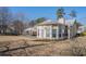 Back exterior of a home with a round sunroom, patio, and large yard at 2210 Burdett Ridge, Atlanta, GA 30349