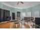 Open living room with hardwood floors, soft teal walls, and natural light from the many windows at 2210 Burdett Ridge, Atlanta, GA 30349