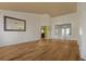 Spacious living room with wood floors, large mirror, and natural light from the double-paned windows at 2210 Burdett Ridge, Atlanta, GA 30349