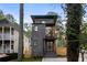 Contemporary three-story home with brick and white siding, and a private driveway at 2870 Daws Se Ave, Atlanta, GA 30317