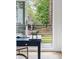 Bright home office features a desk, leafy backyard view, and modern sliding glass doors at 2870 Daws Se Ave, Atlanta, GA 30317