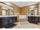 Double vanity bathroom with dark cabinets and a soaking tub at 679 Crosswinds Cir, Marietta, GA 30008