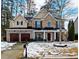 Brick two-story house with a three-car garage and a landscaped yard at 679 Crosswinds Cir, Marietta, GA 30008