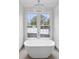 Elegant bathroom with freestanding bathtub and chandelier at 94 Sheridan Dr, Atlanta, GA 30305