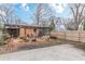 Backyard with a spacious concrete slab, a wooden fence, and a pergola-covered patio area at 1736 Thompson Ave, Atlanta, GA 30344