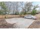 Backyard features a concrete slab and a parked car, all enclosed by a wooden fence at 1736 Thompson Ave, Atlanta, GA 30344