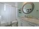 Well-lit bathroom with a round mirror and tiled shower at 1736 Thompson Ave, Atlanta, GA 30344