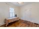 Bedroom with hardwood floors and a window with shutters at 1736 Thompson Ave, Atlanta, GA 30344