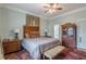 Charming bedroom featuring a ceiling fan, hardwood floors, and a vintage cabinet at 1736 Thompson Ave, Atlanta, GA 30344