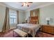 Cozy bedroom with ample natural light, classic wood furniture, and a decorative rug at 1736 Thompson Ave, Atlanta, GA 30344