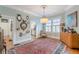 Formal dining room featuring a hardwood floor, elegant light fixture, and plantation shutters at 1736 Thompson Ave, Atlanta, GA 30344