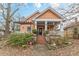 Inviting front porch with a pergola, seating, and neighborhood views at 1736 Thompson Ave, Atlanta, GA 30344