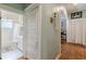 Hallway leading to an updated bathroom with tiled floors at 1736 Thompson Ave, Atlanta, GA 30344