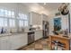 Well-lit kitchen with checkerboard floors, stainless steel appliances, and ample counter space at 1736 Thompson Ave, Atlanta, GA 30344