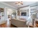 Relaxing living room featuring hardwood floors, built-in shelving, and access to the kitchen at 1736 Thompson Ave, Atlanta, GA 30344