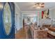 Open-concept living room with a stone fireplace, hardwood floors, and an elegant entry door at 1736 Thompson Ave, Atlanta, GA 30344