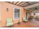 Inviting porch area features wood flooring, trellis, outdoor seating and an orange exterior at 1736 Thompson Ave, Atlanta, GA 30344