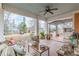 Relaxing covered porch with white columns, an outdoor seating area, and a wood floor at 1736 Thompson Ave, Atlanta, GA 30344