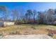 Large backyard with mature trees and a partially fenced perimeter at 2778 Majestic Cir, Dacula, GA 30019