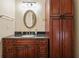 Bathroom with dark wood cabinets and granite countertop at 2778 Majestic Cir, Dacula, GA 30019