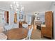 Bright dining area with chandelier and hardwood floors, adjacent to the living room at 2778 Majestic Cir, Dacula, GA 30019